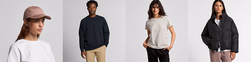 Models wearing assorted AS Colour apparel including cap, sweatshirt, T-shirt, and puffer jacket in neutral tones
