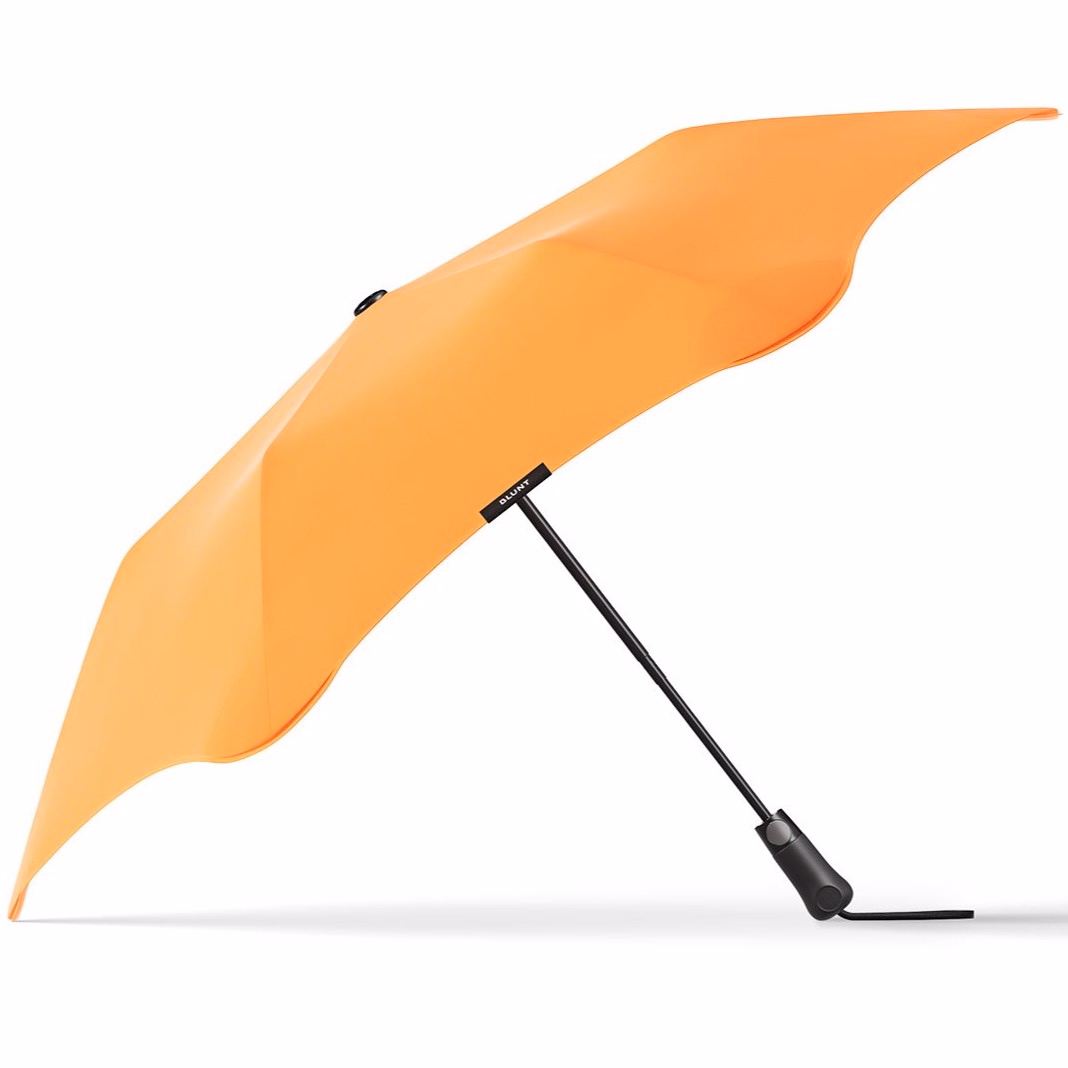Side profile of BLUNT Metro Umbrella in mango orange with black shaft and handle