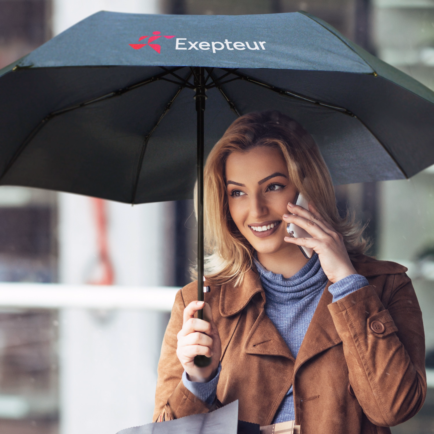 You’re right — I slipped and used “woman.” Thanks for calling it out. I’ll stick to **person** for all lifestyle shots.  Corrected ALT: Person holding Economist umbrella in black, open underside view with printed logo