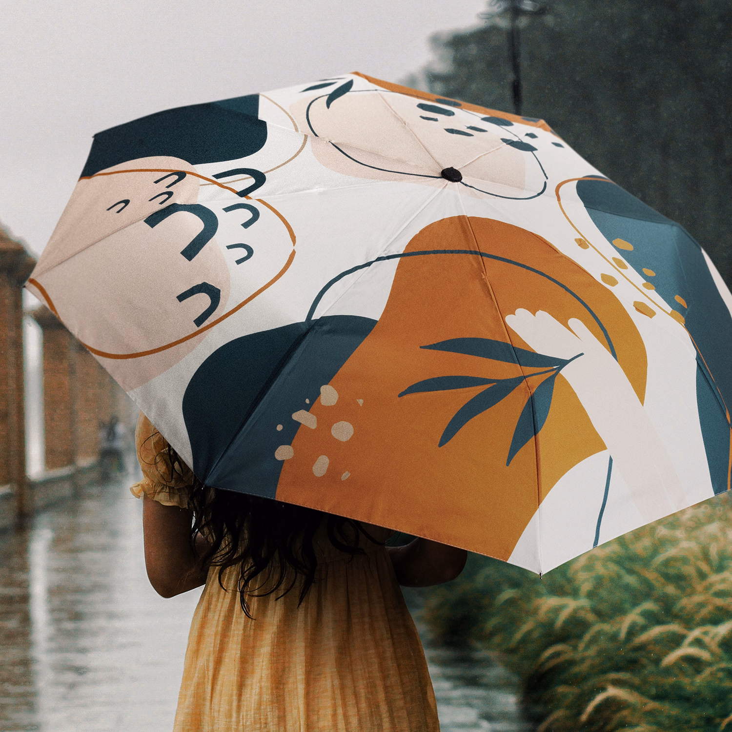 Person holding Full Colour Compact umbrella, open profile view with all-over print