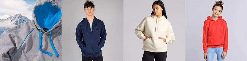 Assorted hoodies and crew sweatshirts in grey, navy, cream, and red shown folded and worn by models