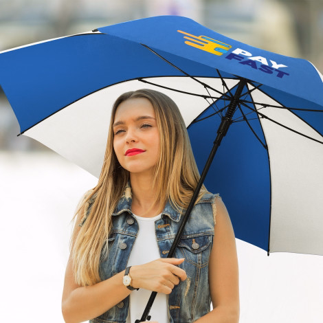 Person holding Hydra Sports umbrella in white and blue, open underside view with branded panel outdoors