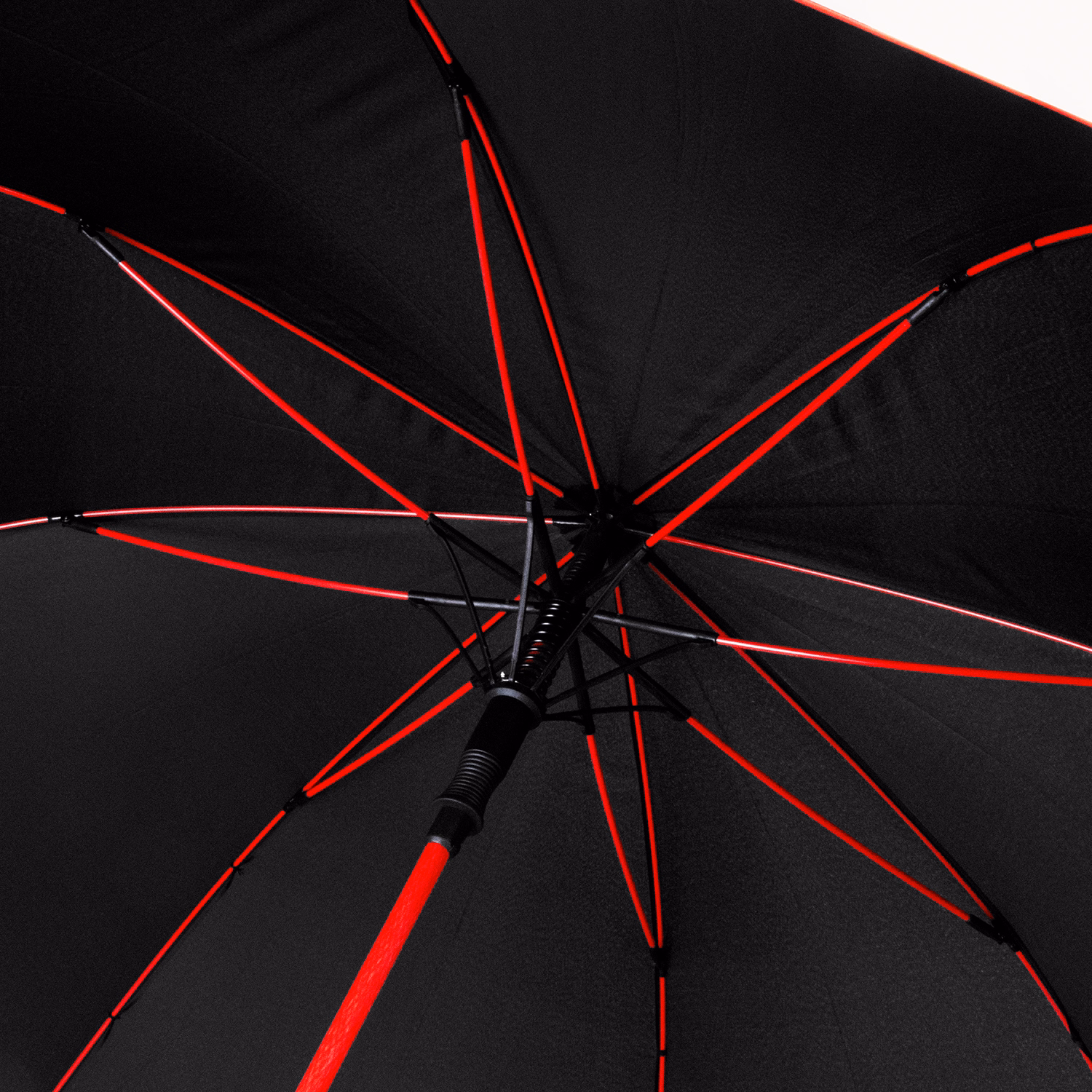 Inside view of open Monsoon umbrella in black with red shaft and ribs