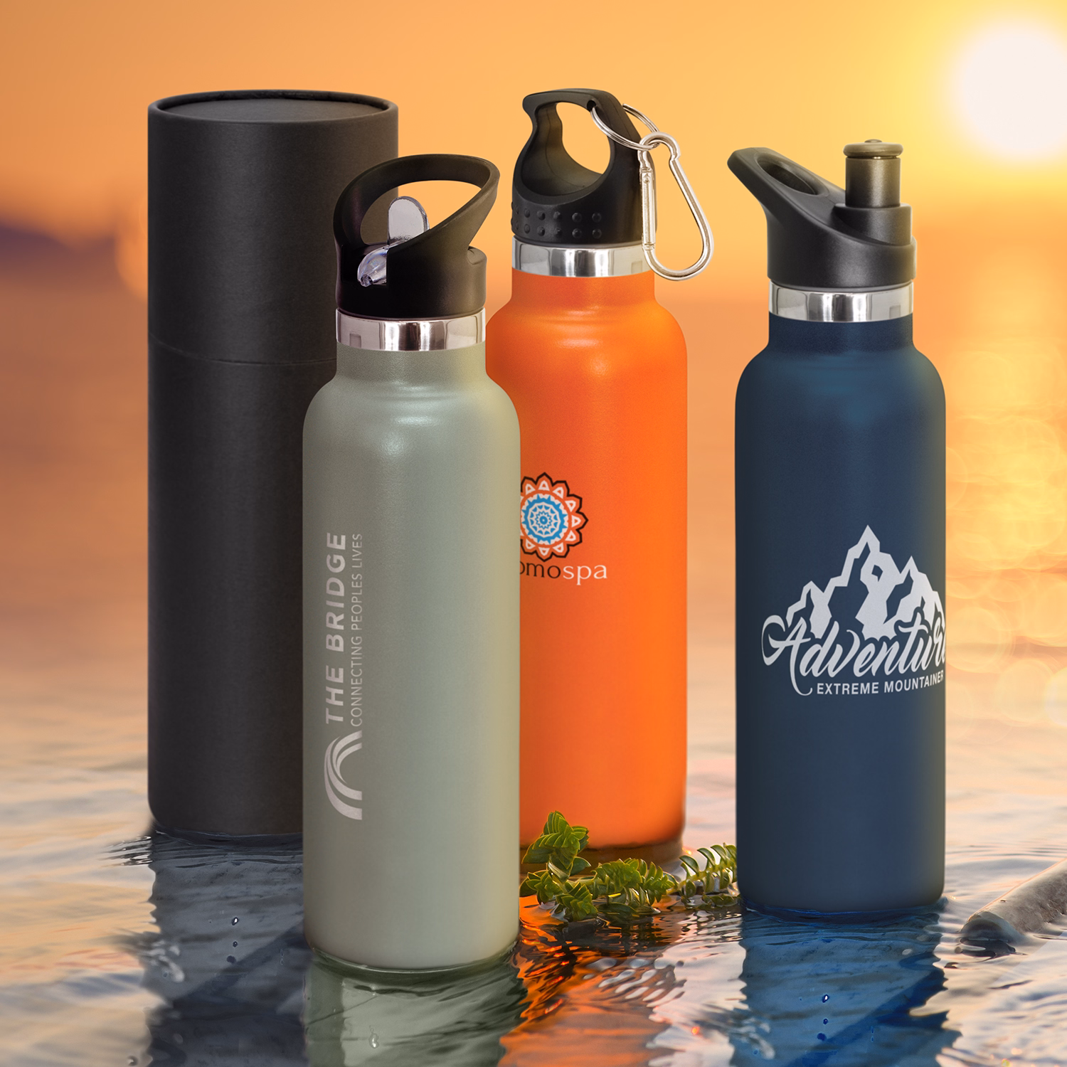 Nomad vacuum bottles with printed logos in assorted colours beside optional black gift tube.