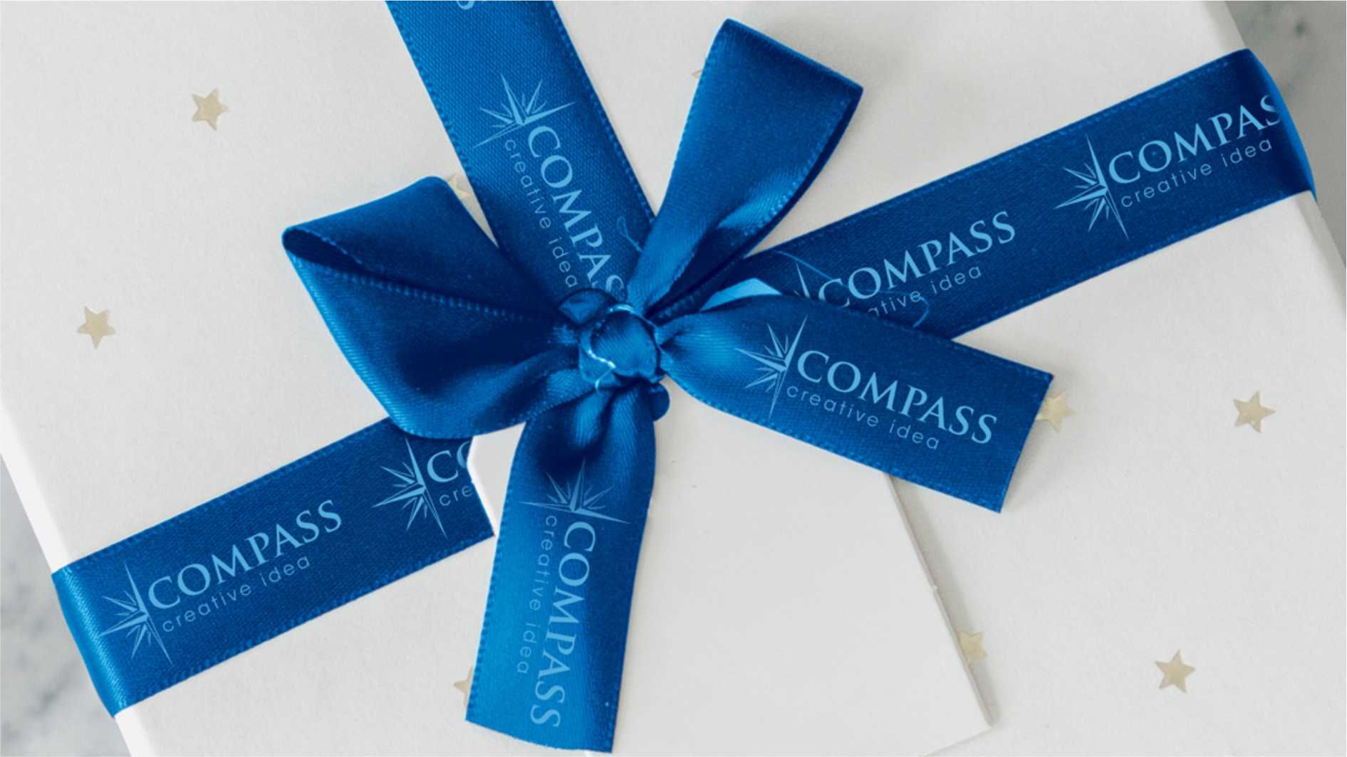Gift box wrapped with blue ribbon printed with company logo